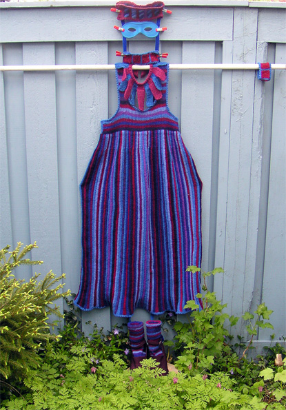 Res�rstickad kl�nning i bl�tt, lia och vinr�tt. Smalr�nder p� l�nden p� kjolen och p� bredden p� livet