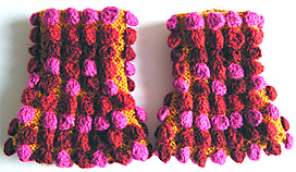 Rtstickade gula pulsvrmare med moucher i rosa, rost och rtt